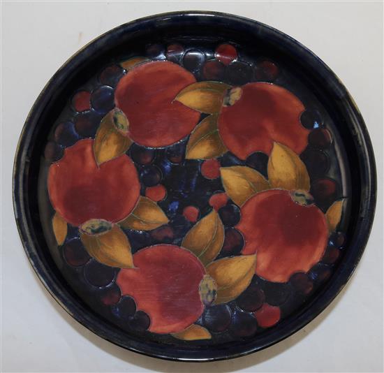 A William Moorcroft pomegranate blue ground footed shallow bowl, diameter 29cm